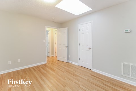 the living room of a house with wood floors and a white door