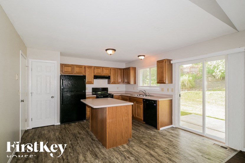 a kitchen with black appliances and wooden cabinets