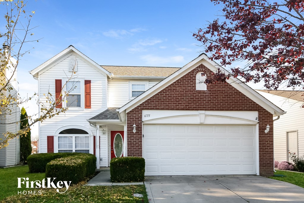 a white house with a white garage door