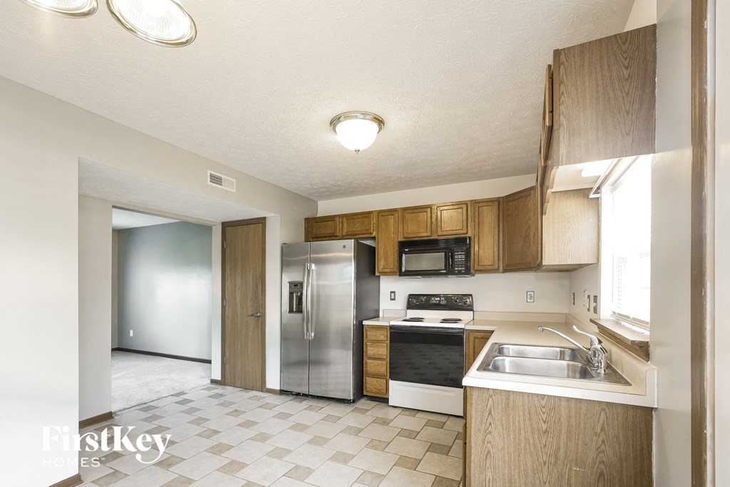 a kitchen with stainless steel appliances and wooden cabinets