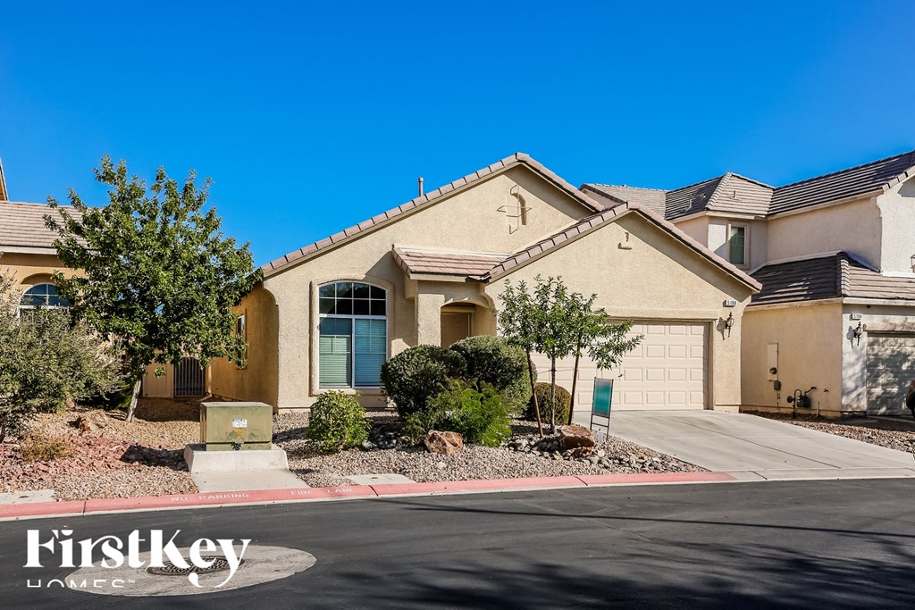 A house with a driveway in front of it and the words "FirstKey Homes" on the sign.