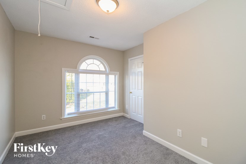 A room with a FirstKey Homes logo on the bottom left corner.