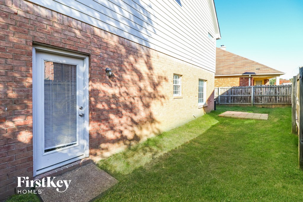 A house with a blue door and a sign that says "FirstKey Homes".