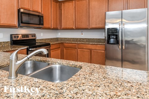 a kitchen with granite counter tops and stainless steel appliances