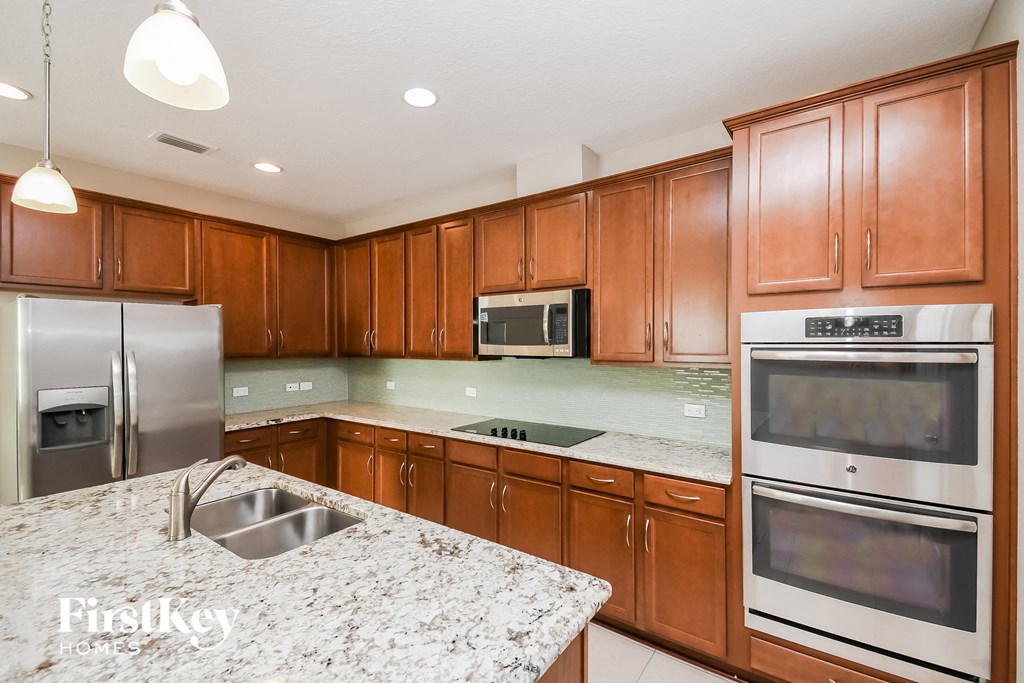 a kitchen with stainless steel appliances and granite counter tops