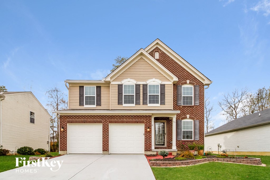 A two-story house with a garage is for sale.