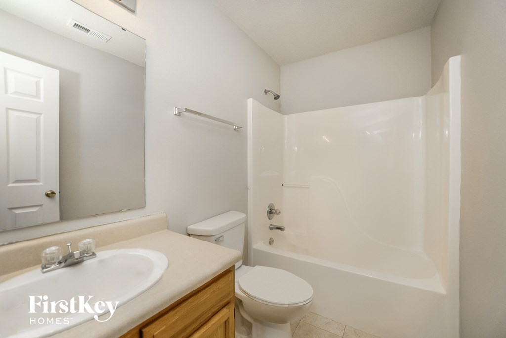 a bathroom with a sink toilet and a shower
