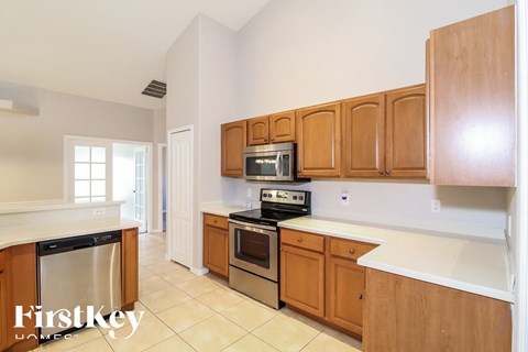 a kitchen with wooden cabinets and stainless steel appliances