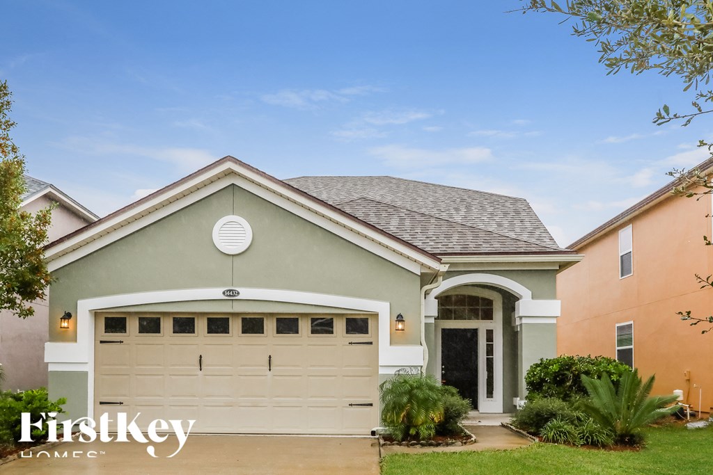 a house with a white garage door in front of it