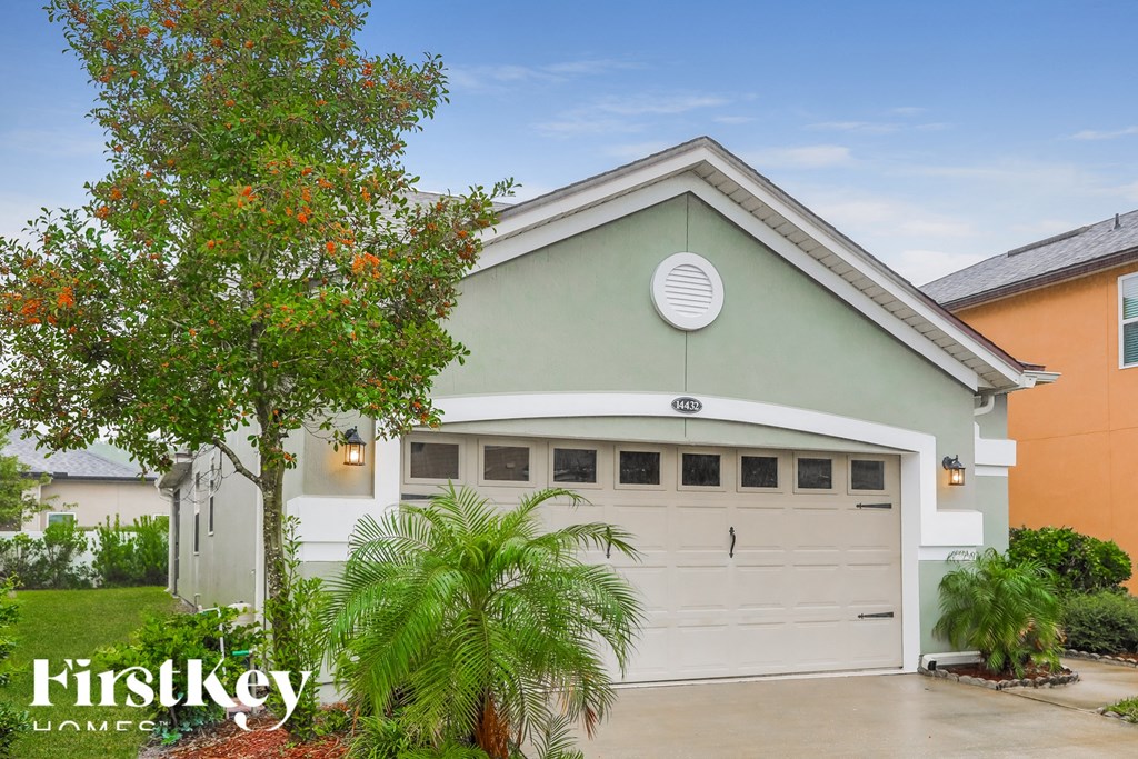 a home with a white garage door in front of it