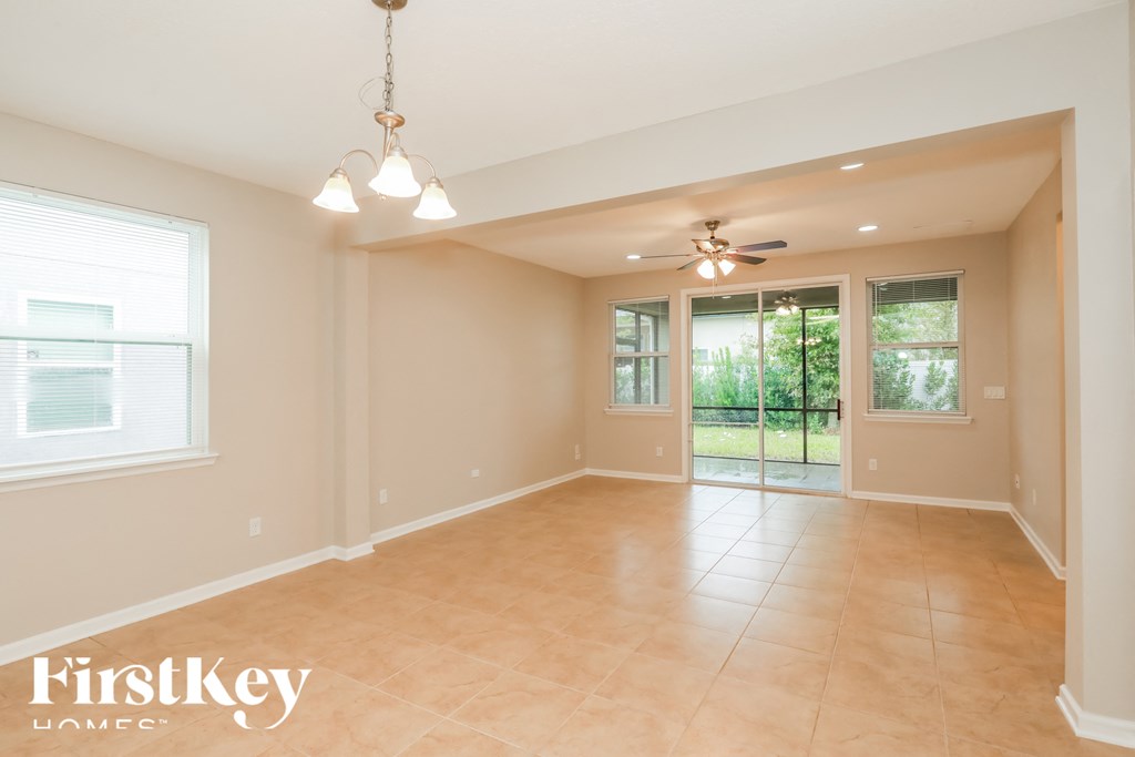 an empty dining room with a ceiling fan