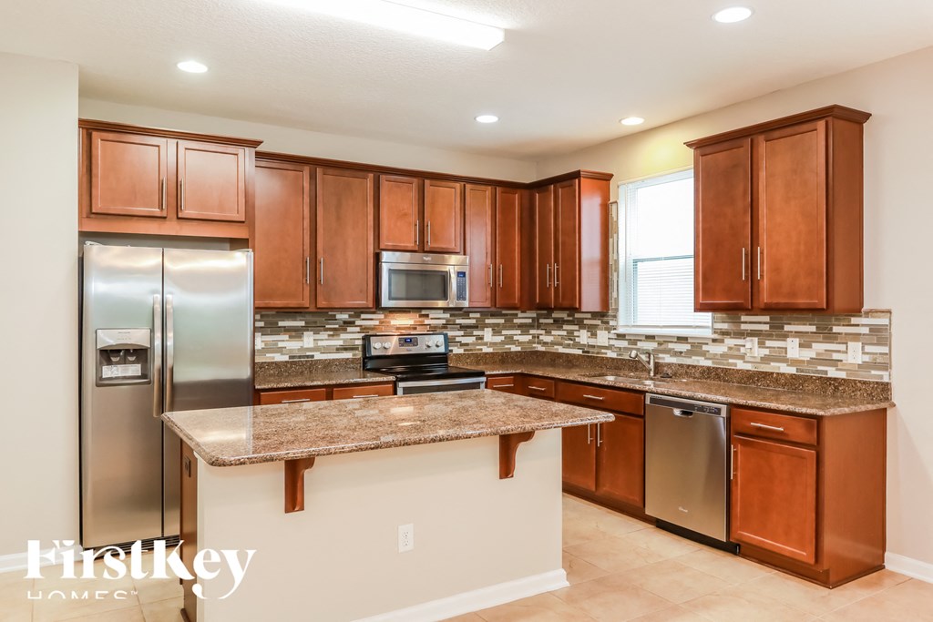 a kitchen with granite counter tops and stainless steel appliances