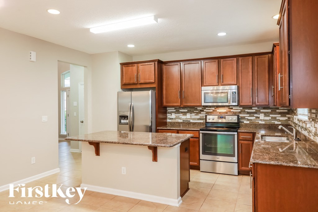 a kitchen with wooden cabinets and stainless steel appliances