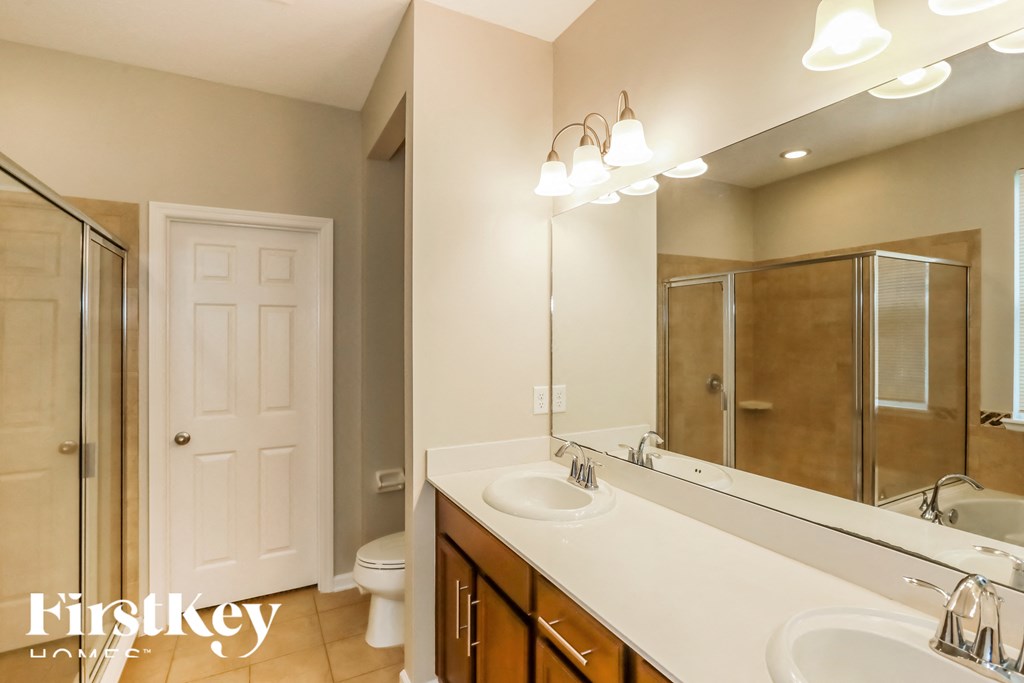 a bathroom with a sink and a mirror and a shower