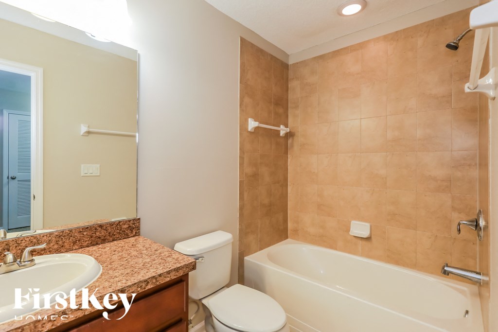a bathroom with a sink toilet and a bath tub
