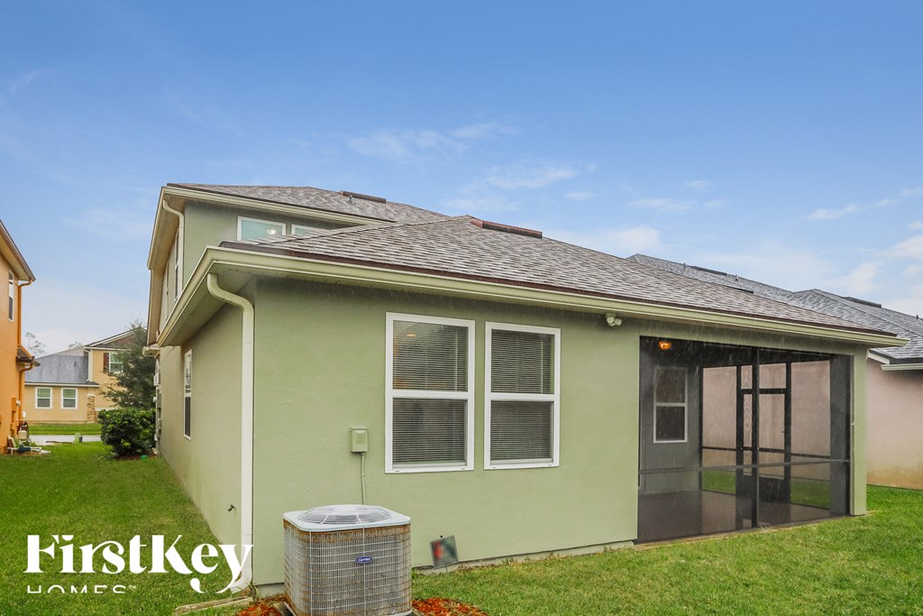 a green house with a trash can in front of it