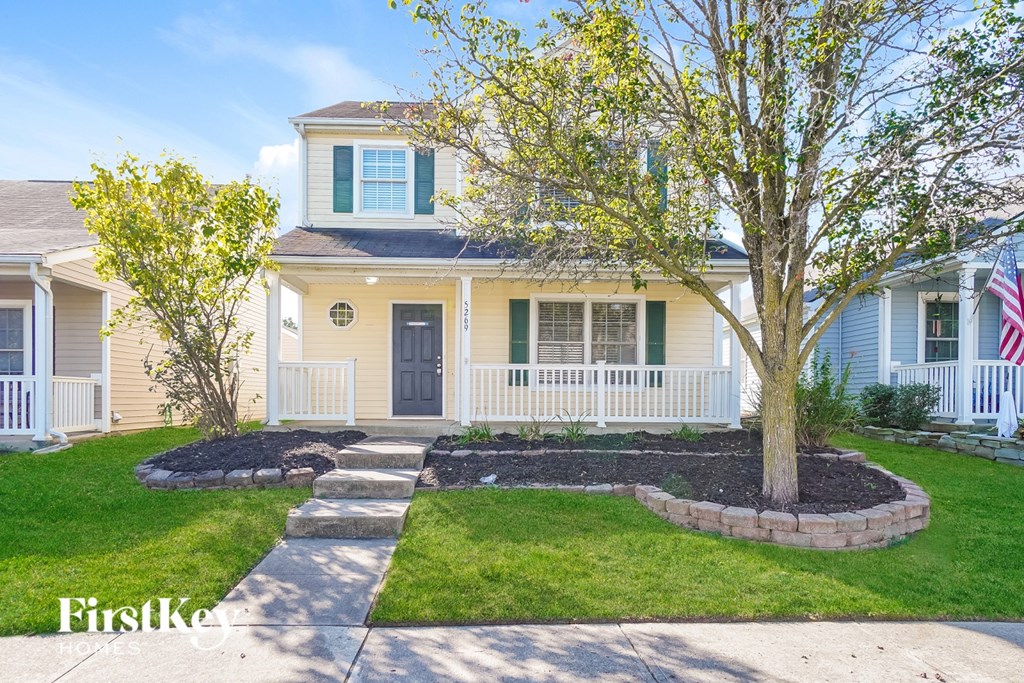 A house with a tree in front of it.