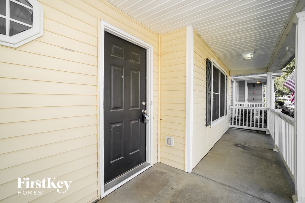 A black door is on the left side of a white door.