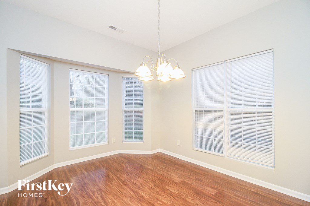 a living room with large windows and a wood floor