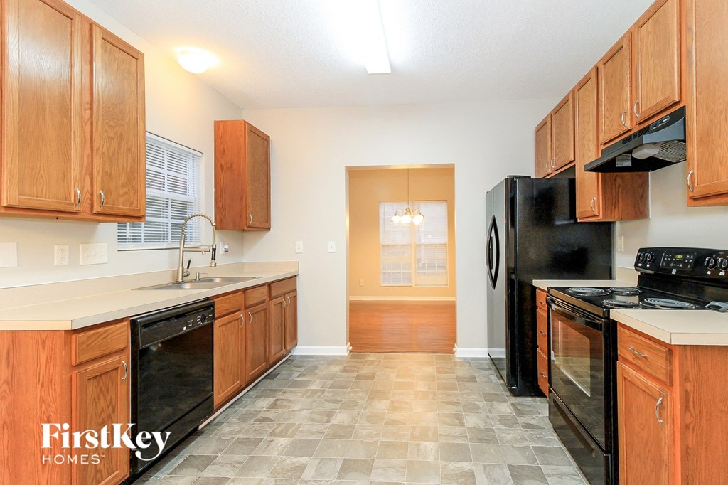 a kitchen with black appliances and wooden cabinets