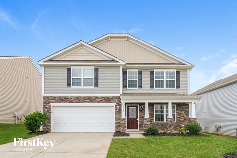 A two-story house with a garage is for sale.