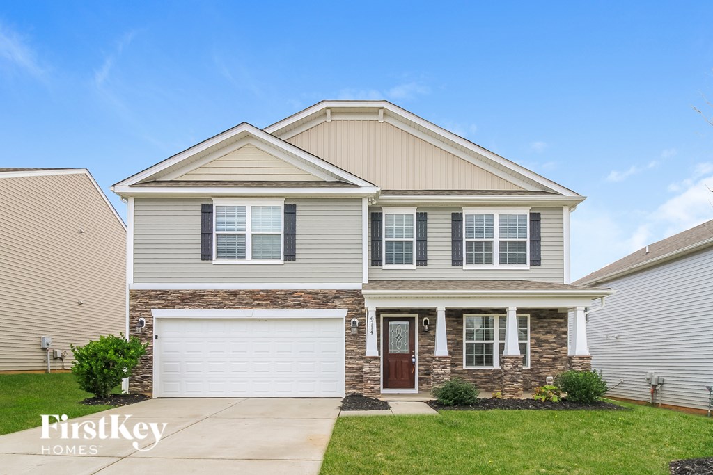 A two-story house with a garage is for sale.