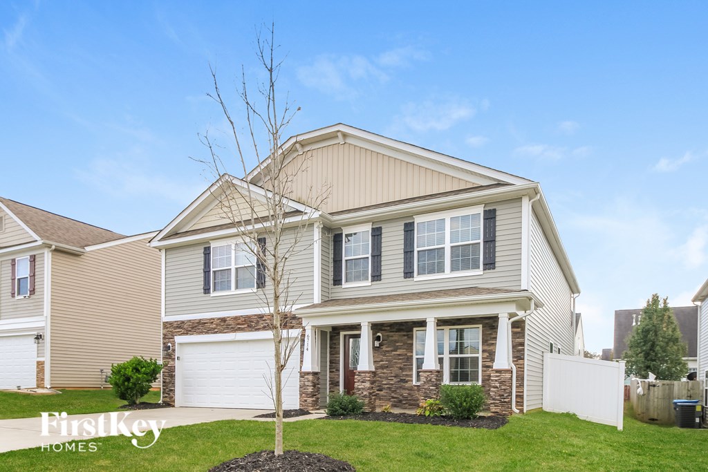 A house with a tree in front of it.