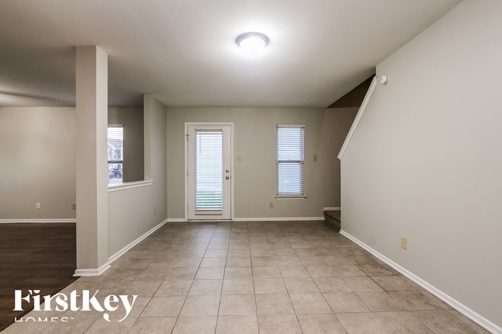 A spacious room with a door and a window.