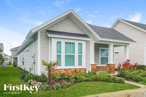 A house with a well-maintained lawn and garden in front.