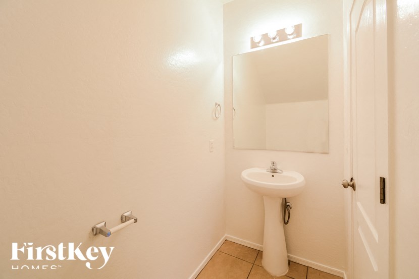 A white sink in a small bathroom.