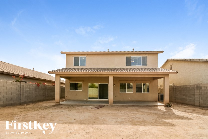 A house with a brown roof and a beige exterior is shown with the words "Firstkey Homes" on the bottom left.