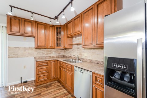 a kitchen with wooden cabinets and stainless steel appliances