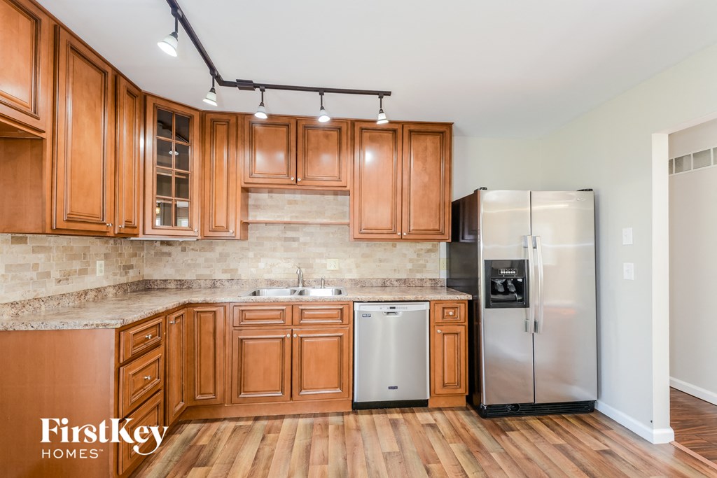 a kitchen with wooden cabinets and stainless steel appliances