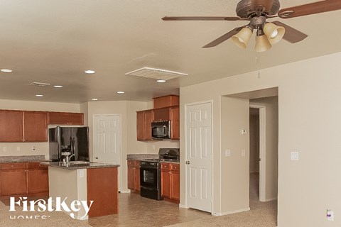 A kitchen with brown cabinets and a white ceiling.