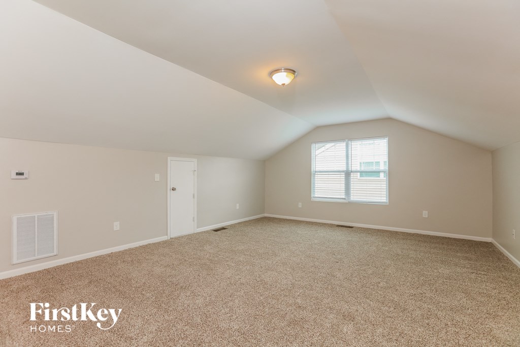 a bedroom with a carpeted floor and a window