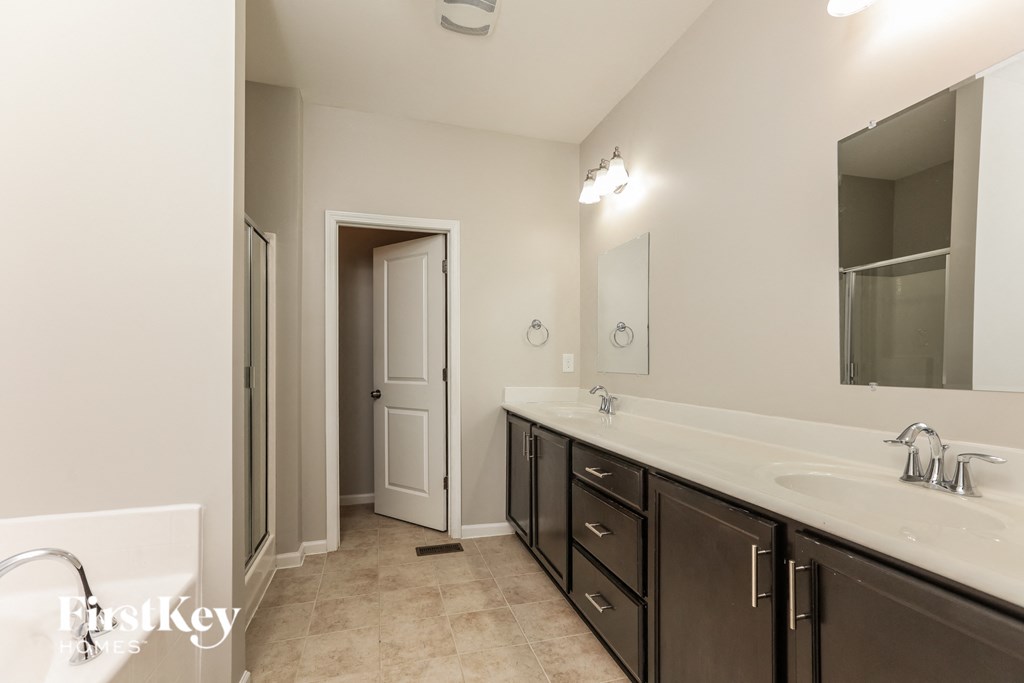 a bathroom with a sink and a mirror and a shower