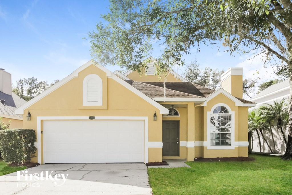 a yellow house with a white garage door