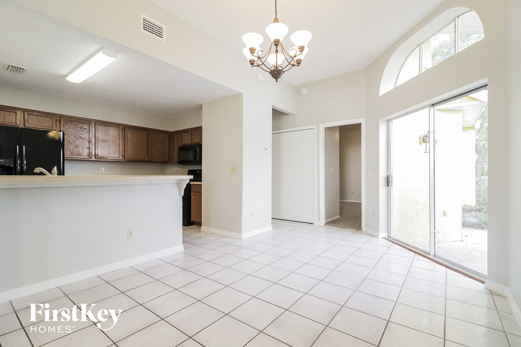 an empty kitchen and living room with a door to the patio