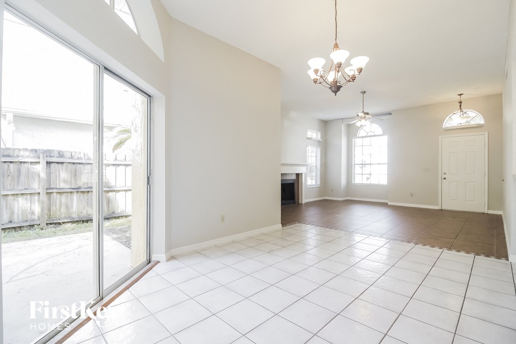 an empty living room with sliding glass doors to a patio