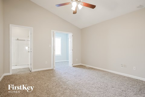 a bedroom with carpet and a ceiling fan