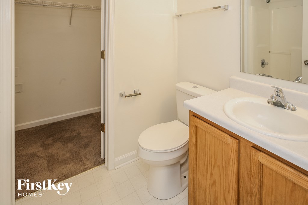 a bathroom with a toilet and a sink and a shower