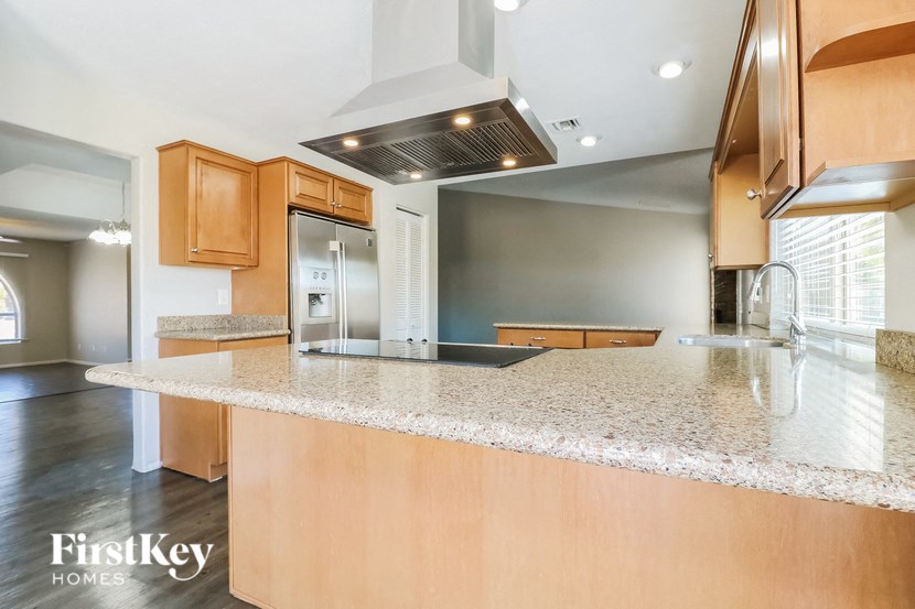 a kitchen with granite countertops and a large island