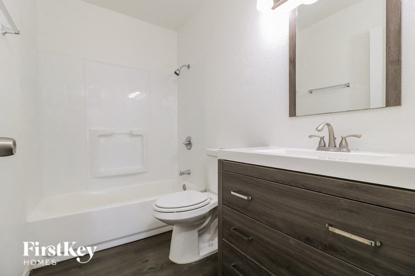 a bathroom with a toilet and a sink and a bath tub