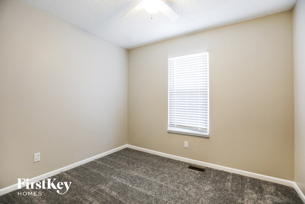 a room with a carpeted floor and a window