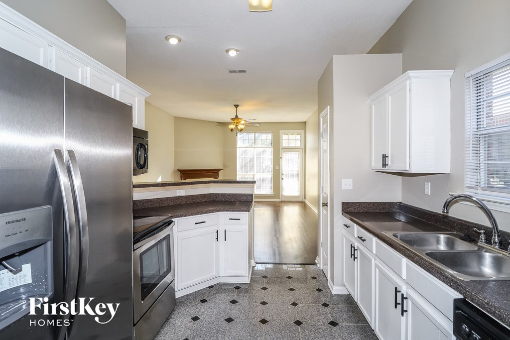 a kitchen with stainless steel appliances and white cabinets