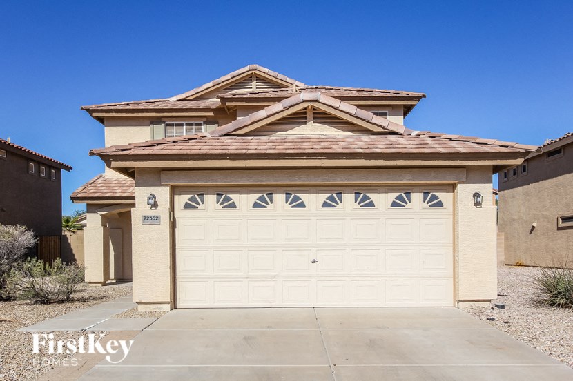 a garage with a white door in front of a house
