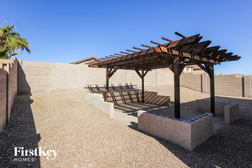 a group of wooden benches under a wooden pavilion