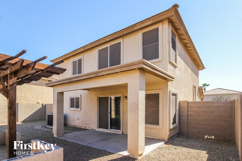 a remodeled home with a patio and a gate