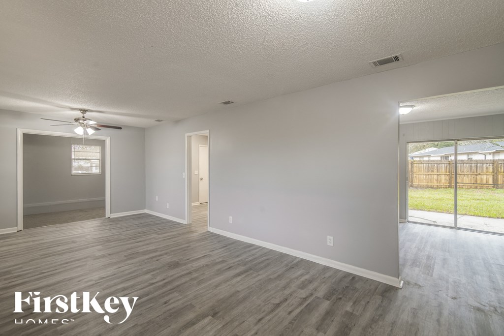 the living room and dining room of an empty house