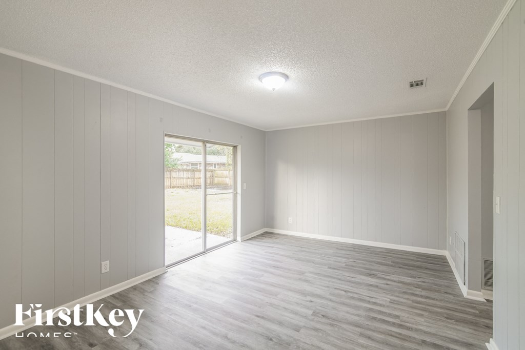 the living room of a new home with white walls and wood floors
